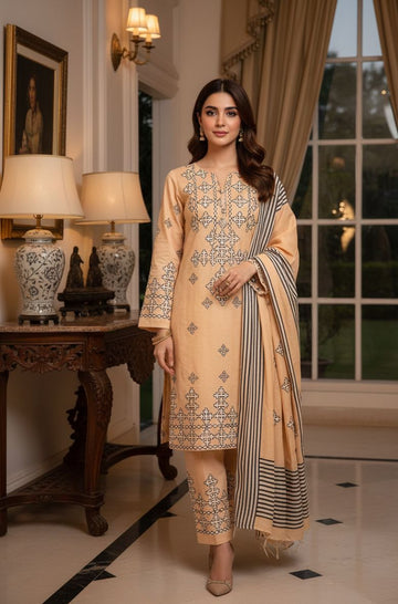 Woman in a beige embroidered outfit standing in an elegant room with lamps and decor.